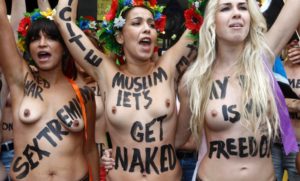 Members from the topless women's rights group Femen, take part in a demonstration near their 'training camp' in Paris