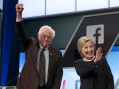 Democratic U.S. presidential candidates Senator Bernie Sanders and Hillary Clinton wave before the start of the Univision News and Washington Post Democratic U.S. presidential candidates debate in Kendall