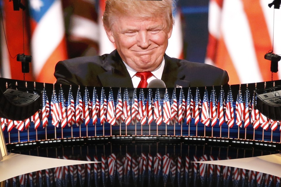 U.S. Republican Presidential Nominee Donald Trump is seen on a large television monitor as he speaks at the Republican National Convention in Cleveland, Ohio, U.S. July 21, 2016. REUTERS/Rick Wilking - RTSJ4DR